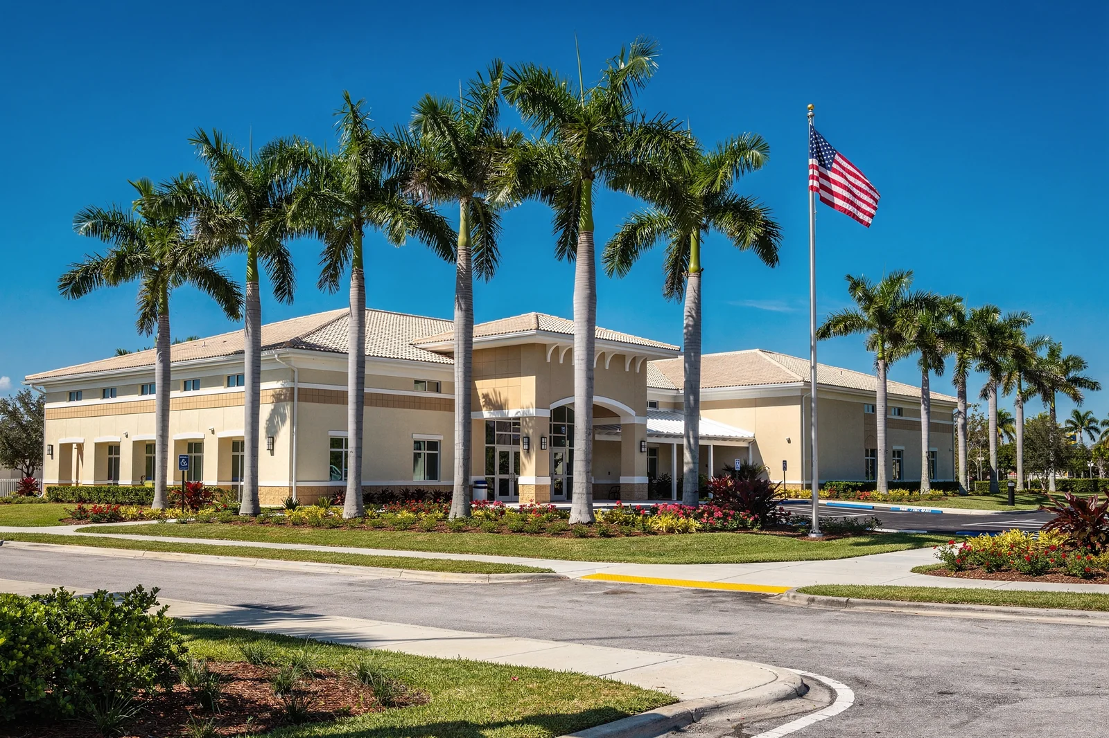 Collier County Public Schools campus in Florida with palm trees and American flag