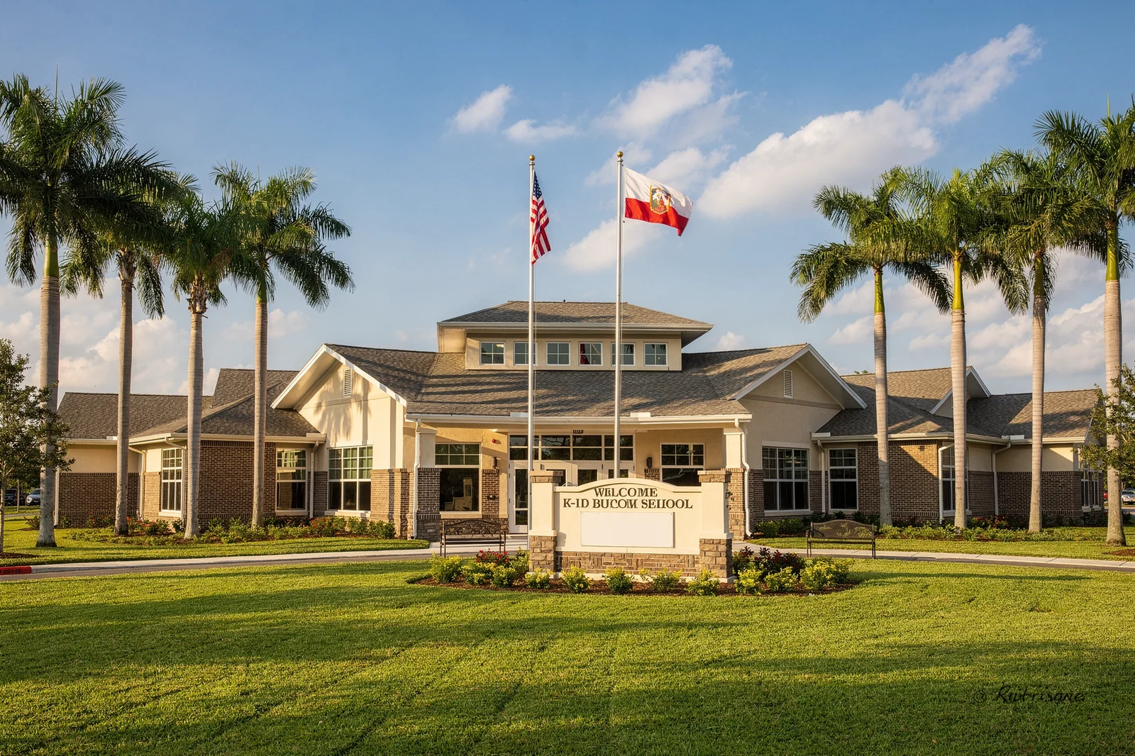 Florida K-12 public school building with American and state flags on a sunny day